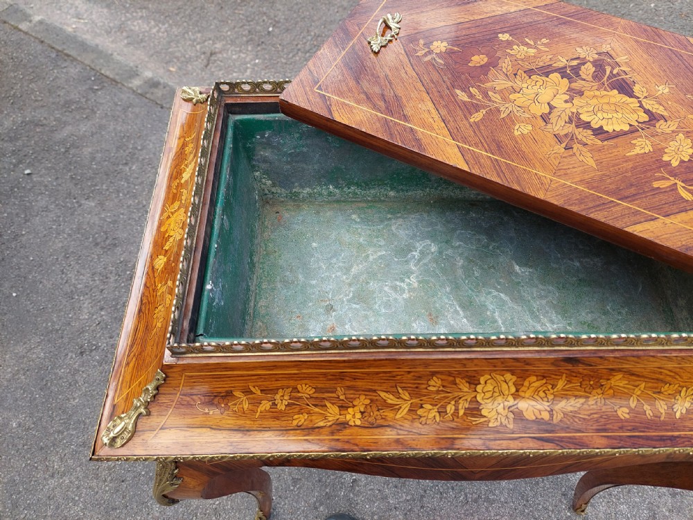 A Victorian kingwood jardiniere table featuring floral marquetry inlays, slender cabriole legs with gilt-metal mounts, and a brass gallery rim. View X
