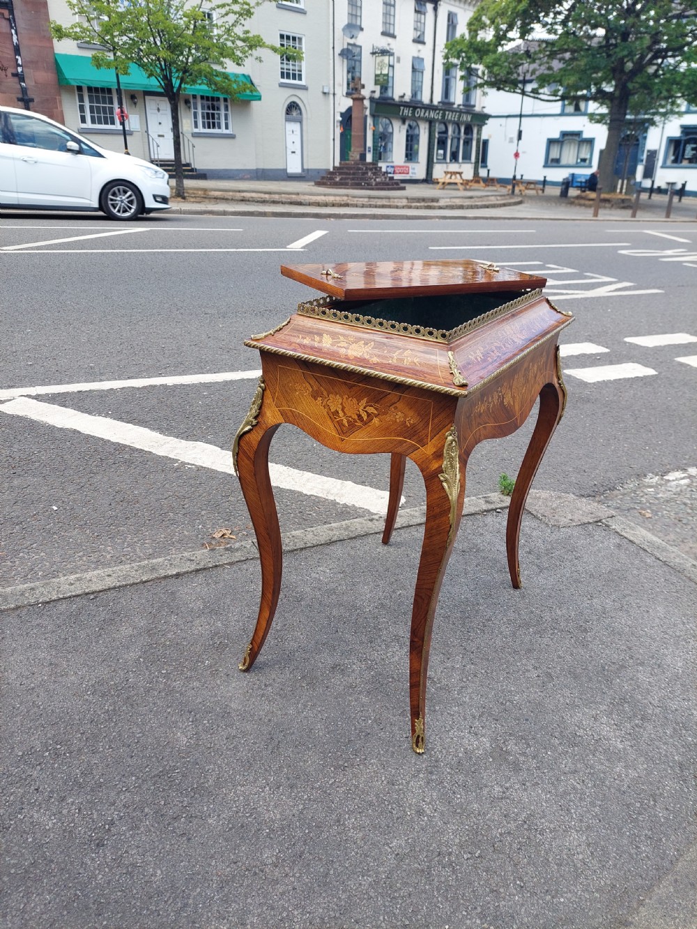 A Victorian kingwood jardiniere table featuring floral marquetry inlays, slender cabriole legs with gilt-metal mounts, and a brass gallery rim. View XI