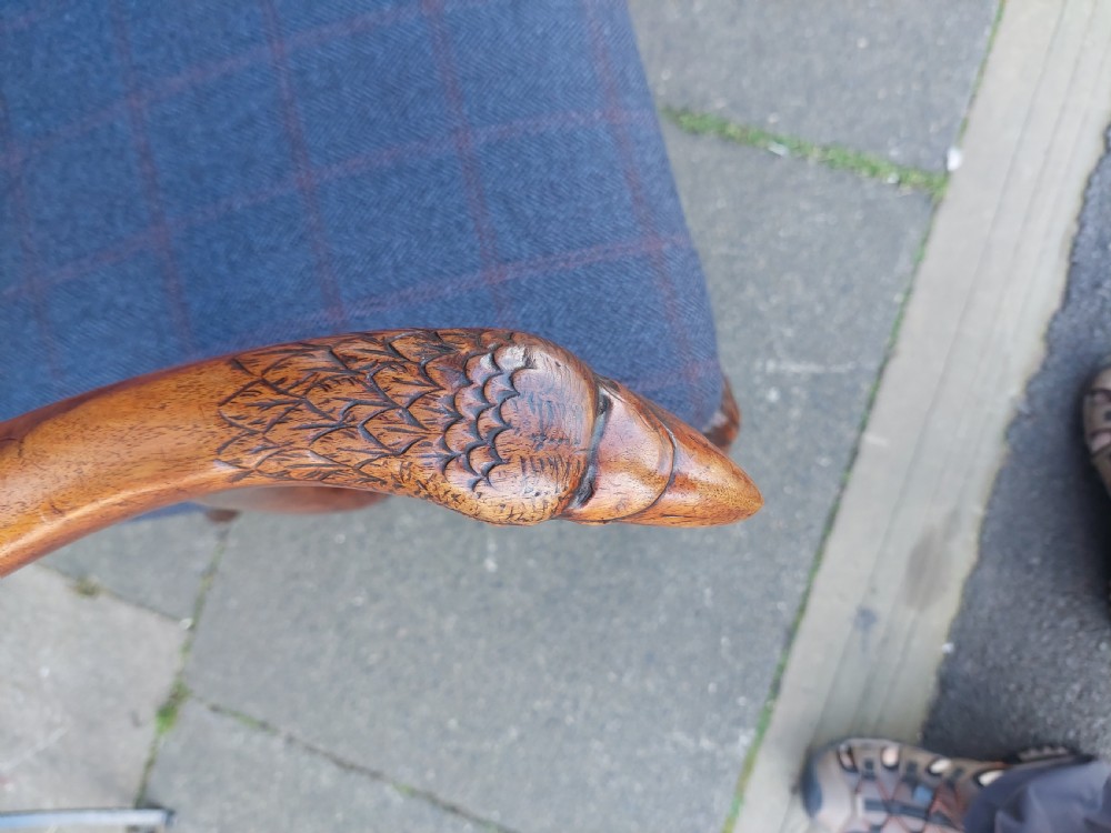 An early twentieth-century Georgian Revival high-backed armchair upholstered in blue fabric with carved walnut legs and eagle head handrests. View VII