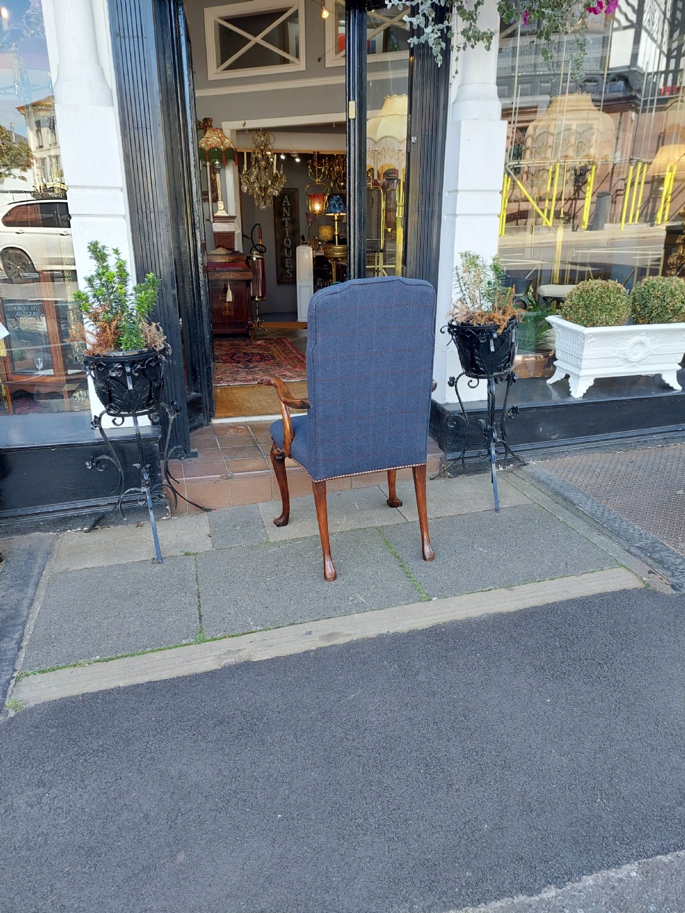 An early twentieth-century Georgian Revival high-backed armchair upholstered in blue fabric with carved walnut legs and eagle head handrests. View VIII