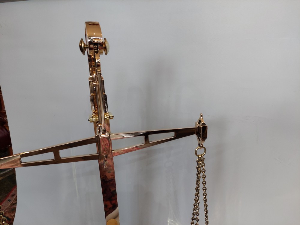 A set of Victorian polished brass beam balance scales with suspended pans and nested weights. View IV