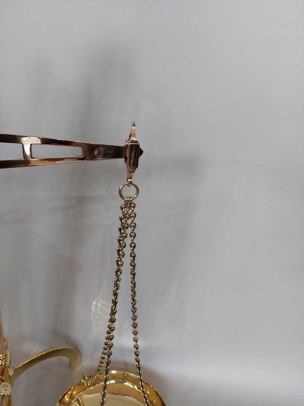 A set of Victorian polished brass beam balance scales with suspended pans and nested weights. View VII