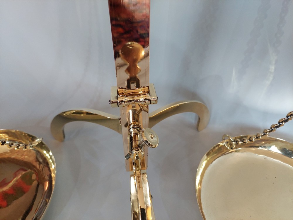 A set of Victorian polished brass beam balance scales with suspended pans and nested weights. View VIII