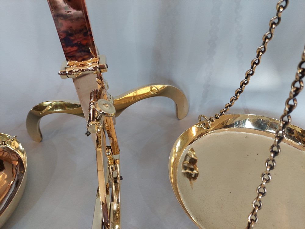 A set of Victorian polished brass beam balance scales with suspended pans and nested weights. View XI