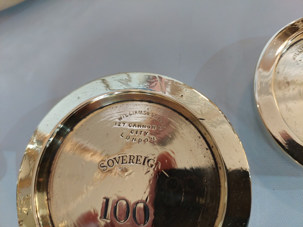 A set of Victorian polished brass beam balance scales with suspended pans and nested weights. View XV