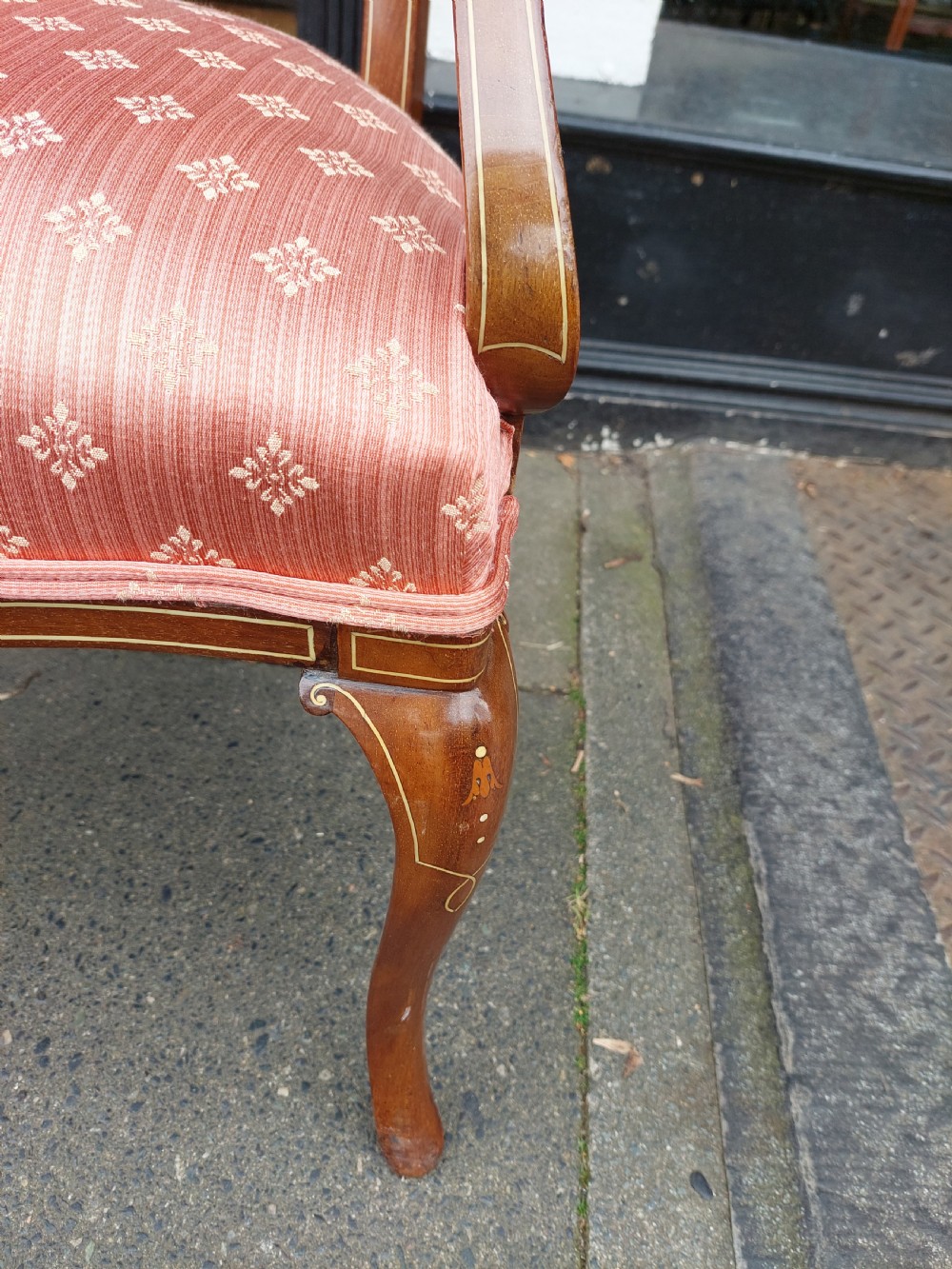 A pair of late Victorian mahogany armchairs featuring inlaid wood detail, padded armrests, and patterned pink fabric upholstery. View V