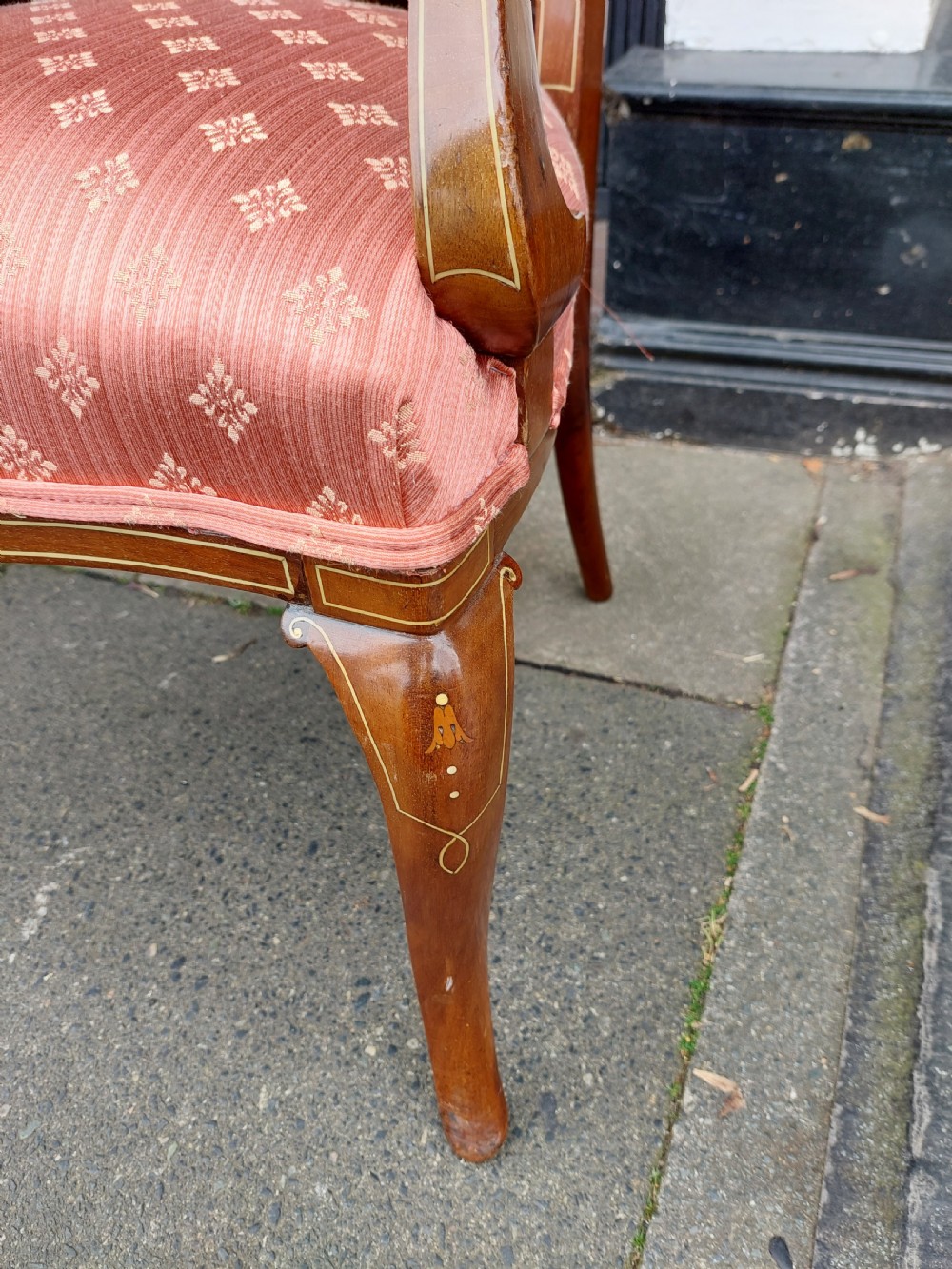 A pair of late Victorian mahogany armchairs featuring inlaid wood detail, padded armrests, and patterned pink fabric upholstery. View VI