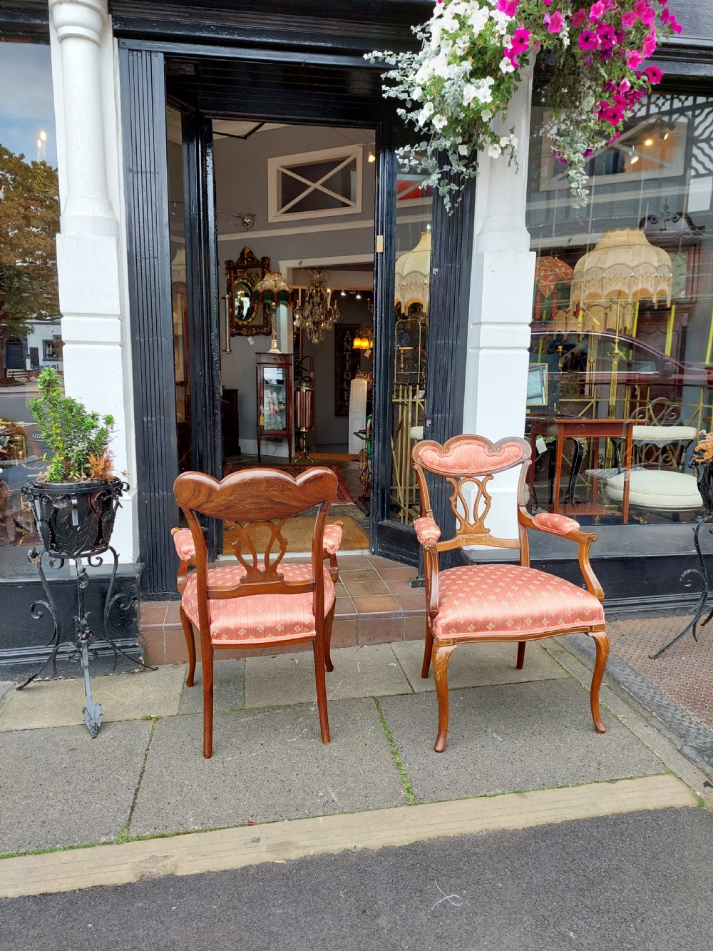 A pair of late Victorian mahogany armchairs featuring inlaid wood detail, padded armrests, and patterned pink fabric upholstery. View VIII