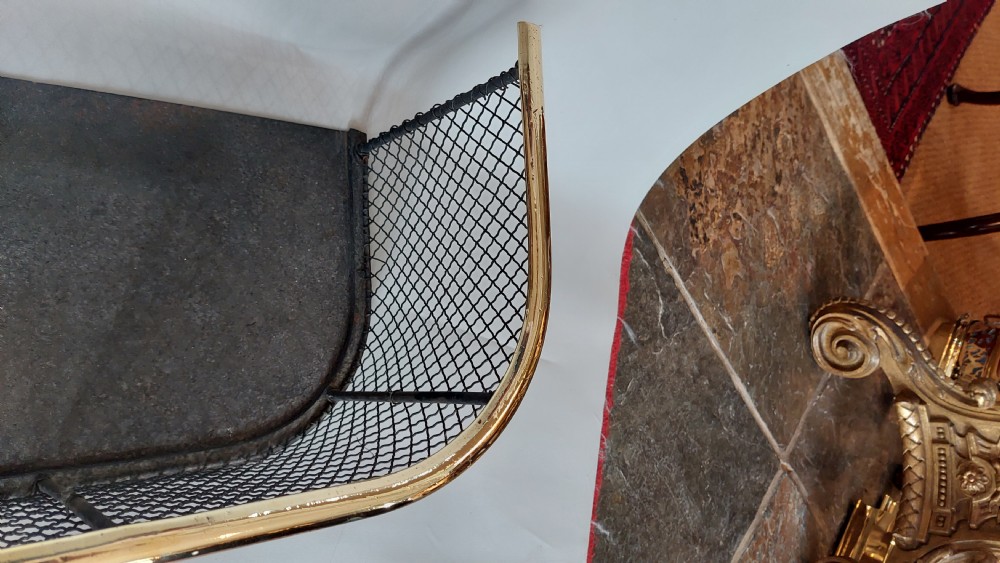 An early nineteenth-century U-shaped nursery fire guard with a polished brass top rail and a woven dark wire mesh body. View III