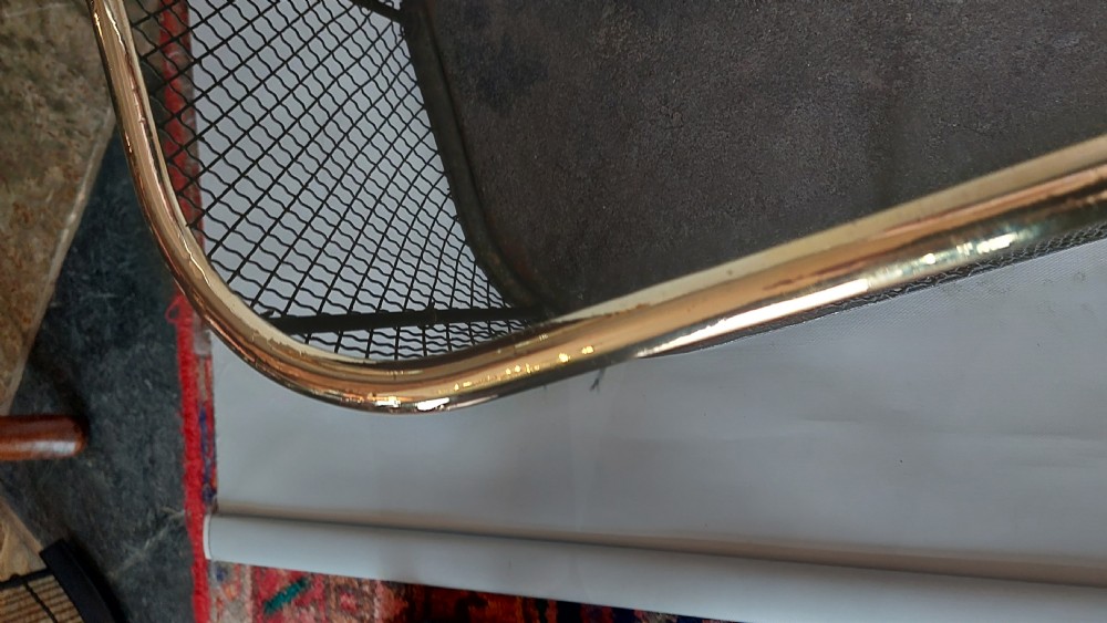 An early nineteenth-century U-shaped nursery fire guard with a polished brass top rail and a woven dark wire mesh body. View IV