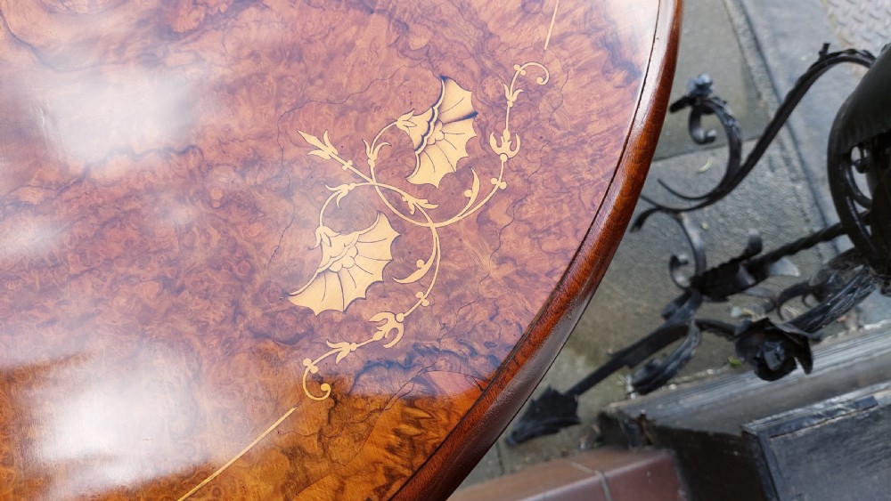A Victorian burr walnut Sutherland table featuring floral marquetry inlay, twin turned column supports, and carved splayed legs fitted with ceramic castors. View VIII