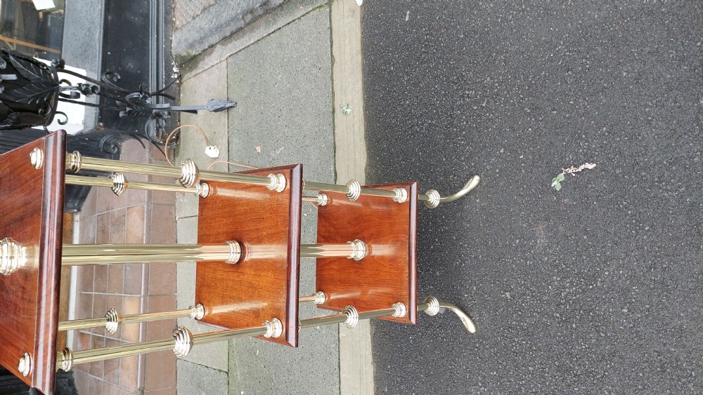 A pair of early twentieth-century floor lamps crafted from brass and polished mahogany with three tiered square shelves and cream scalloped fringed shades. View III
