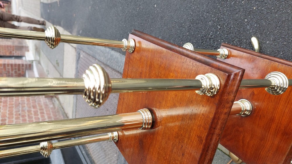 A pair of early twentieth-century floor lamps crafted from brass and polished mahogany with three tiered square shelves and cream scalloped fringed shades. View IV