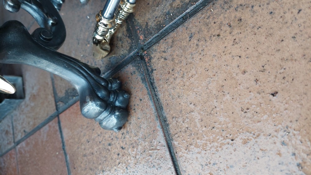 A set of Victorian hearth accessories comprising three metal fire tools resting across a pair of cast iron and brass decorated andirons. View IV