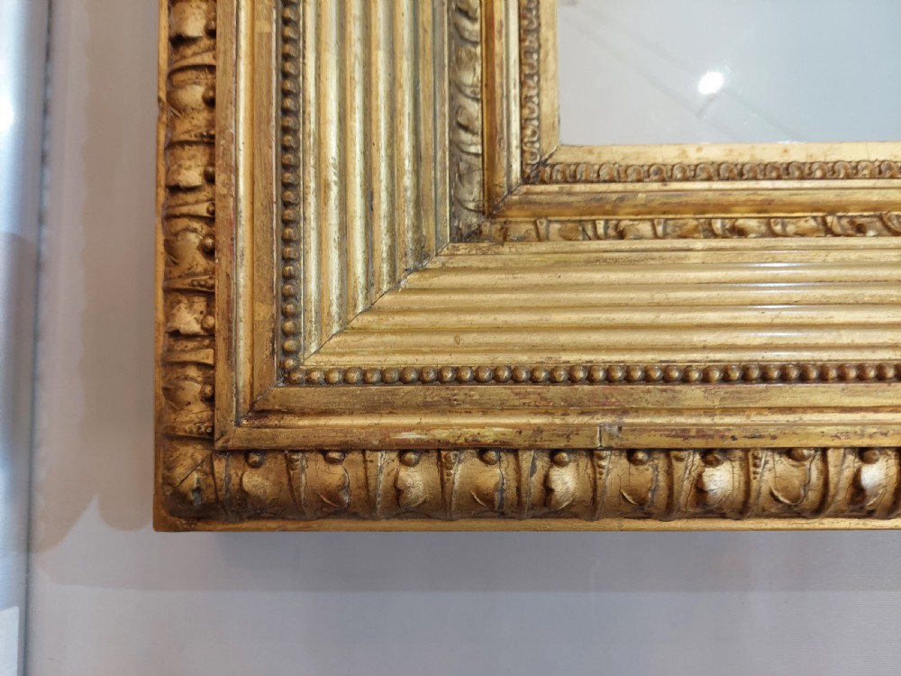 A rectangular Victorian wall mirror featuring a deep giltwood and gesso frame with ribbed moulding and beaded inner borders. View VII