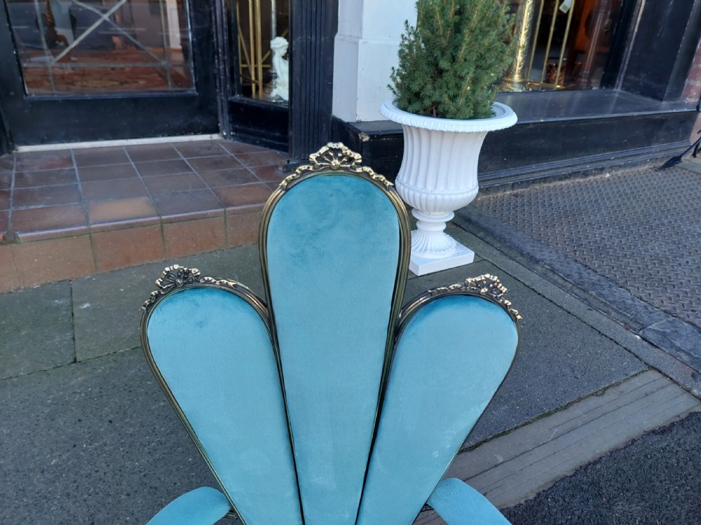 A 1920s miniature metal-framed armchair with turquoise blue velvet upholstery and a fan-shaped backrest. View V