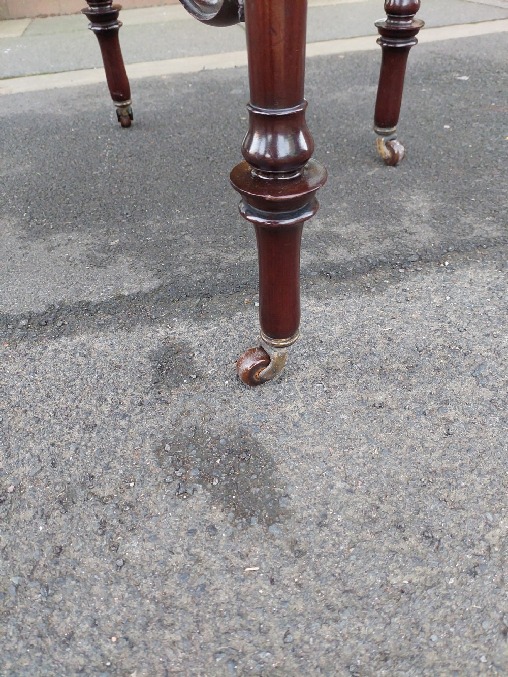 A late 19th-century mahogany centre table featuring a shaped top with marquetry inlay, turned legs, crossed stretcher with central finial, and brass castors. View VII