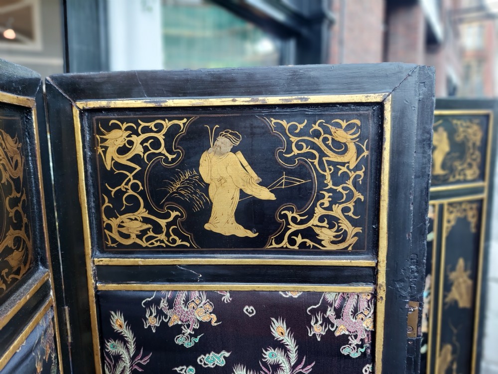An eight-panel black lacquered folding screen with gold chinoiserie figures and floral patterned panels. View IV