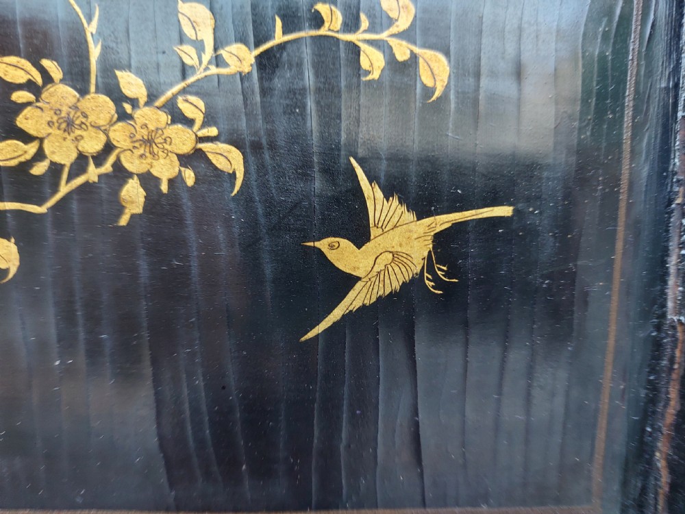 An eight-panel black lacquered folding screen with gold chinoiserie figures and floral patterned panels. View XI