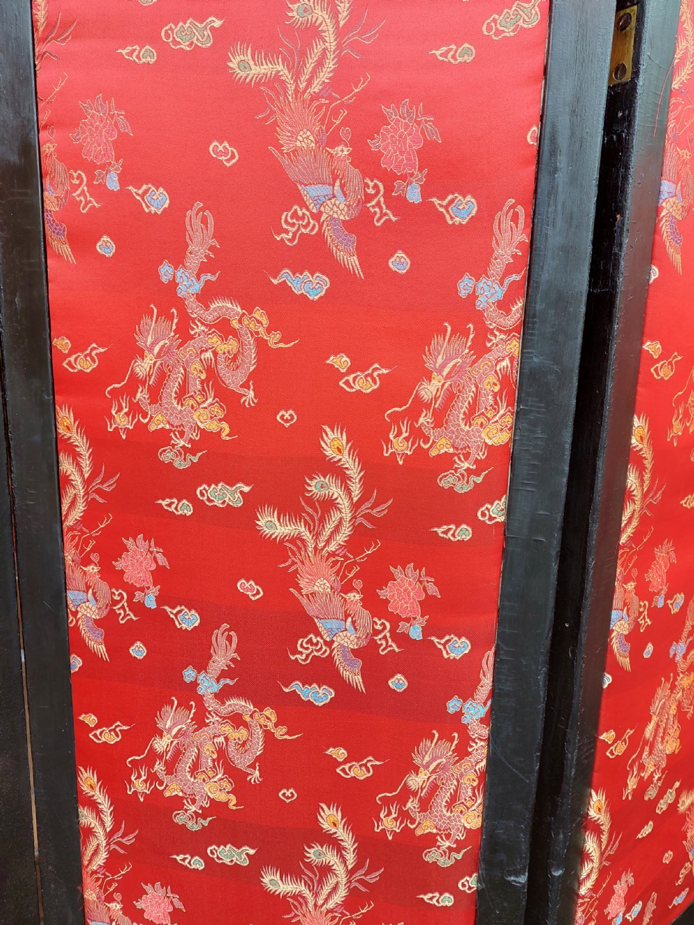 An eight-panel black lacquered folding screen with gold chinoiserie figures and floral patterned panels. View XIII