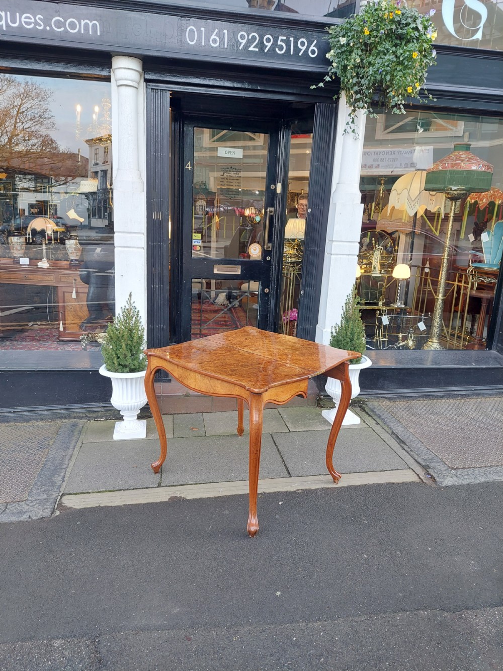 A 19th-century Danish burr walnut tea table featuring a serpentine fold-over top supported by slender cabriole legs. View III