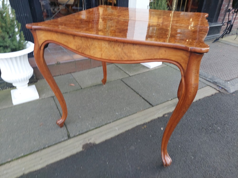 A 19th-century Danish burr walnut tea table featuring a serpentine fold-over top supported by slender cabriole legs. View IV