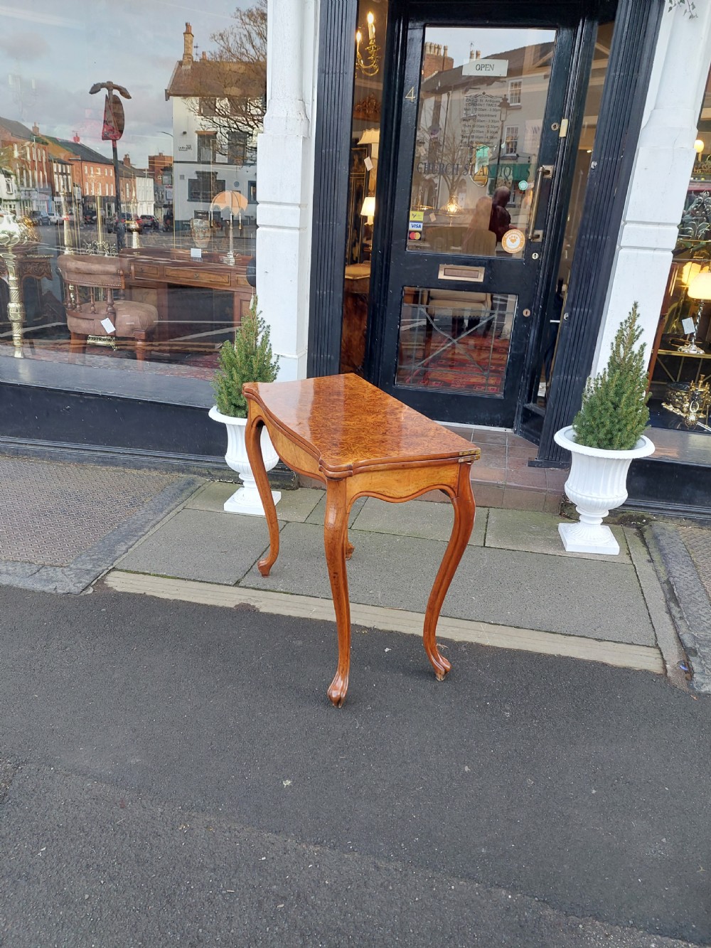 A 19th-century Danish burr walnut tea table featuring a serpentine fold-over top supported by slender cabriole legs. View V