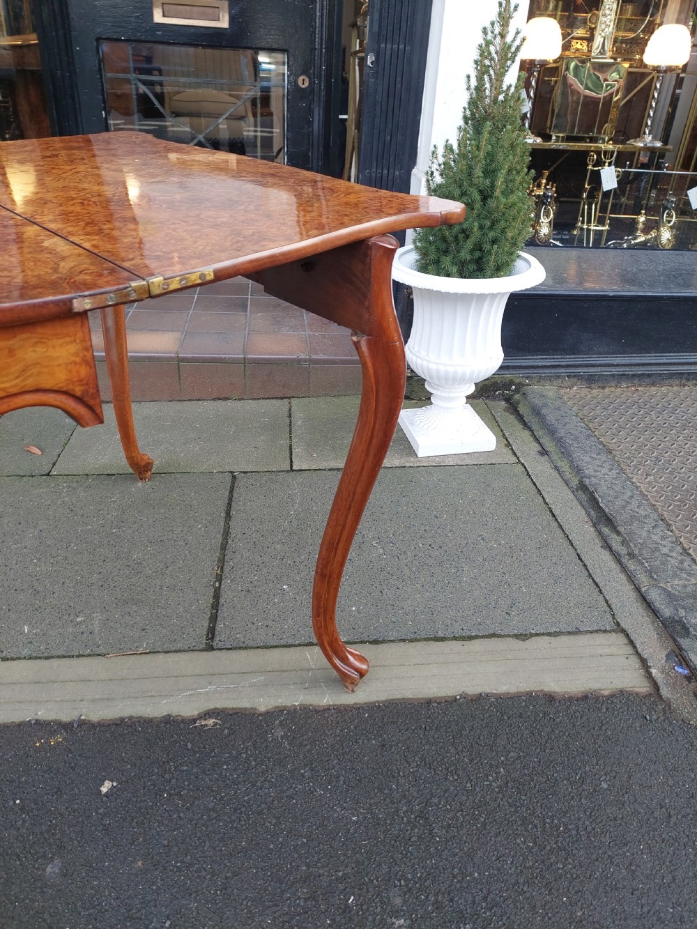 A 19th-century Danish burr walnut tea table featuring a serpentine fold-over top supported by slender cabriole legs. View VI
