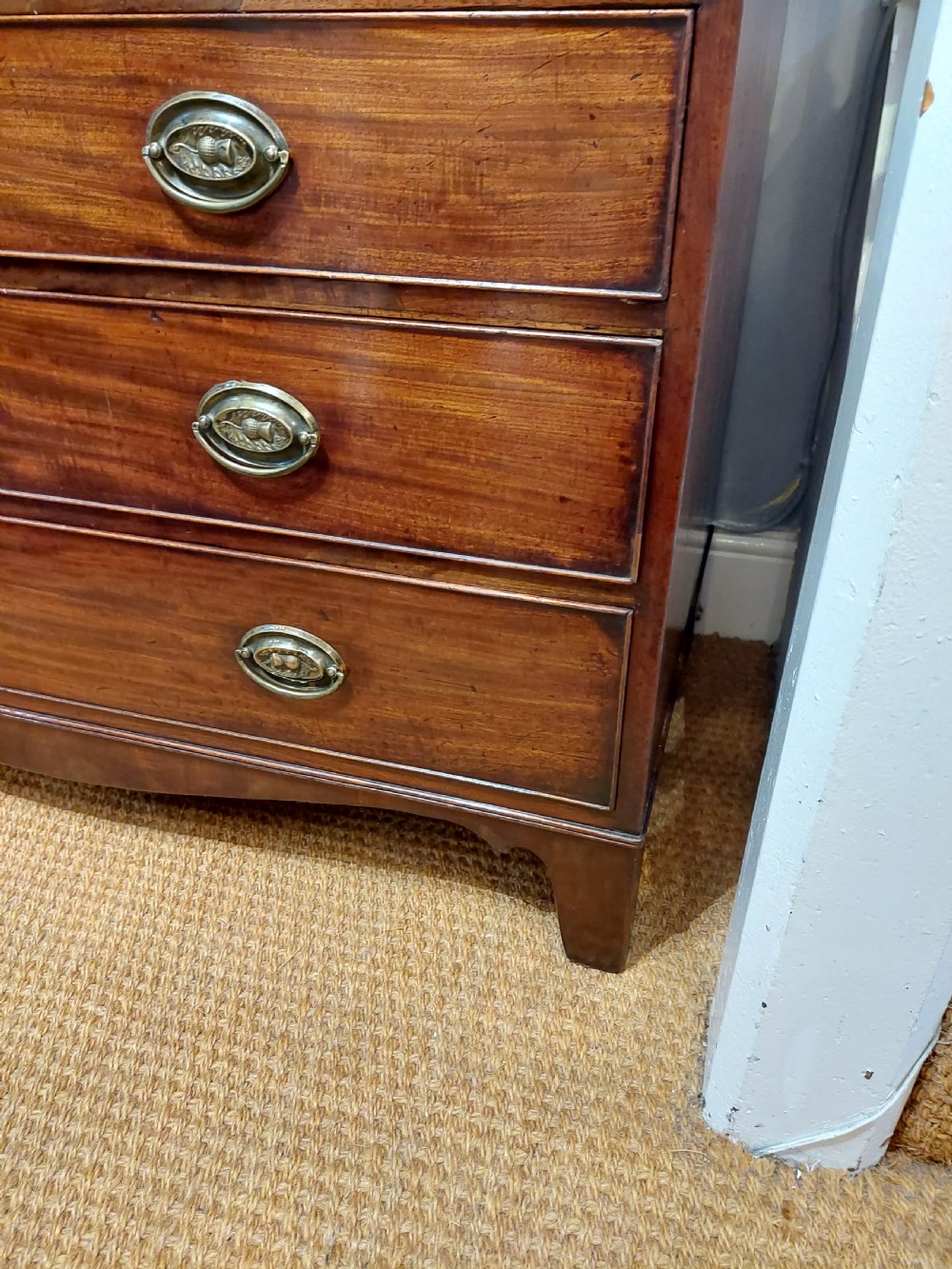 A tall Regency mahogany secretaire bookcase featuring two upper glazed doors with intricate geometric glazing bars above a chest of drawers with oval brass handles. View XVIII