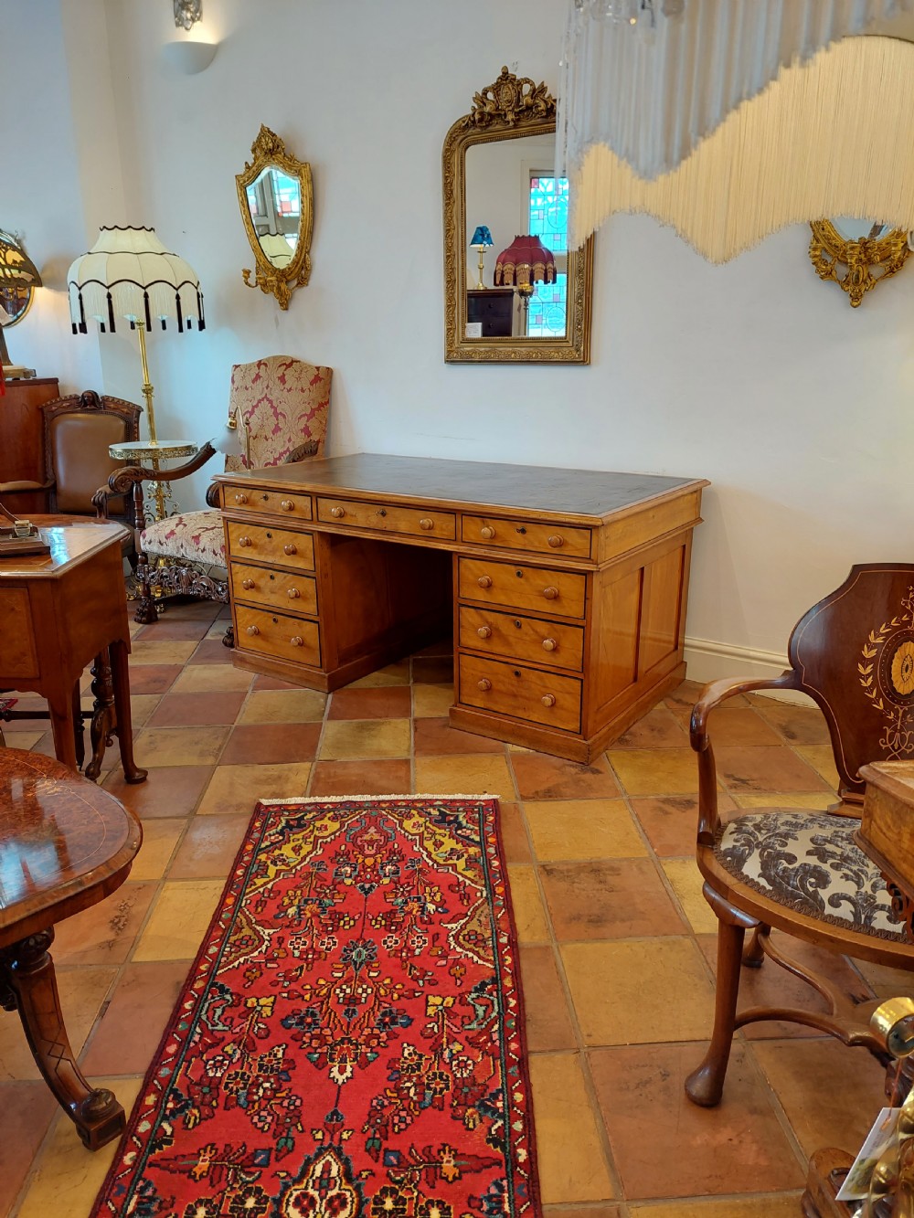 A tall Regency mahogany secretaire bookcase featuring two upper glazed doors with intricate geometric glazing bars above a chest of drawers with oval brass handles. View XXIV