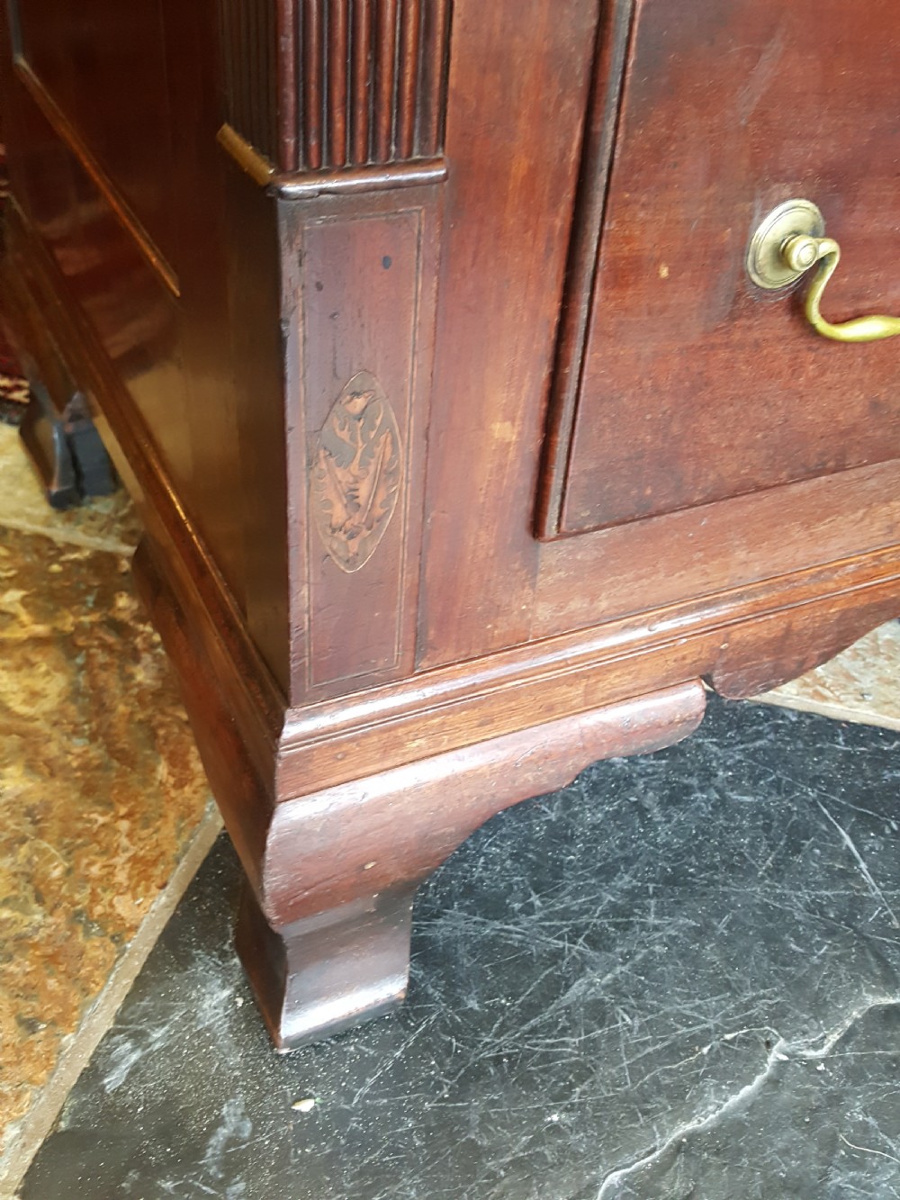 A George III mahogany Lancashire mule chest with brass swan-neck handles, fluted quarter columns, diamond keyhole inlays, and ogee bracket feet. View II