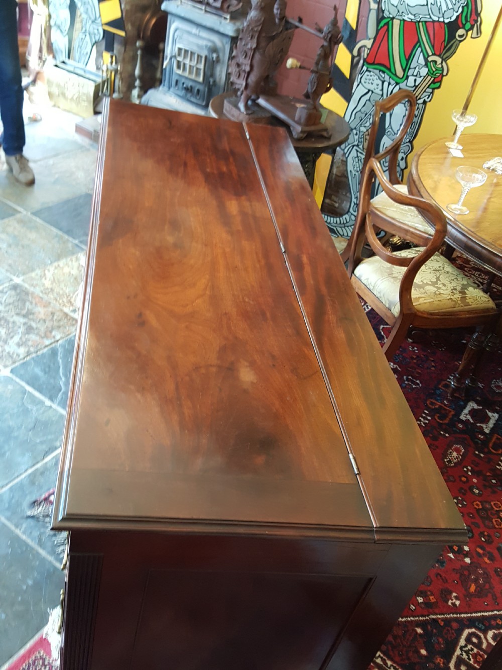 A George III mahogany Lancashire mule chest with brass swan-neck handles, fluted quarter columns, diamond keyhole inlays, and ogee bracket feet. View IV