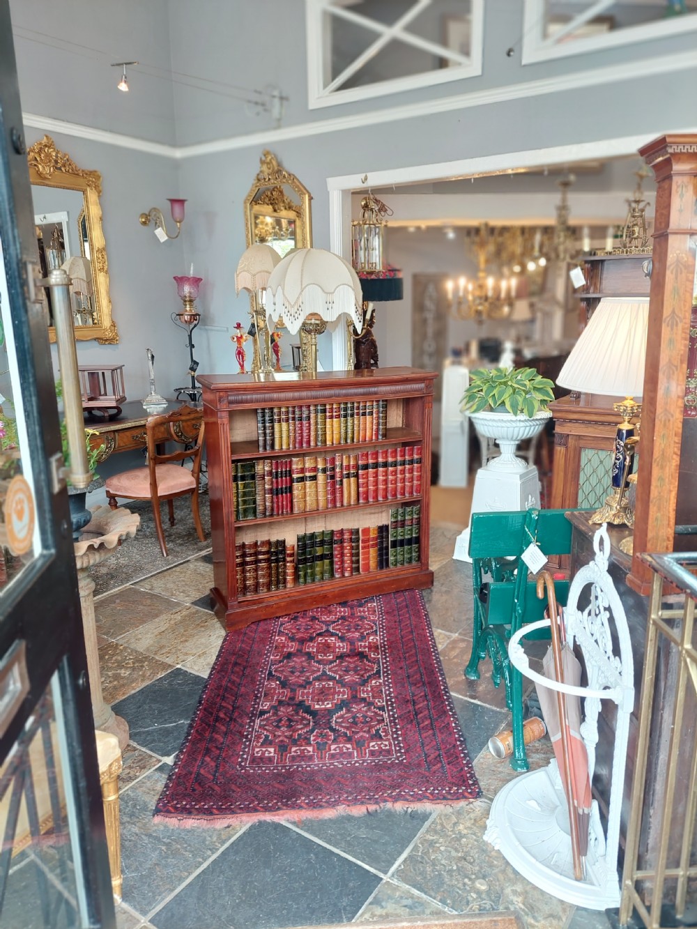 A late 19th-century mahogany dwarf open bookcase with a reeded top frieze, fluted side pilasters, and three fixed shelves. View II