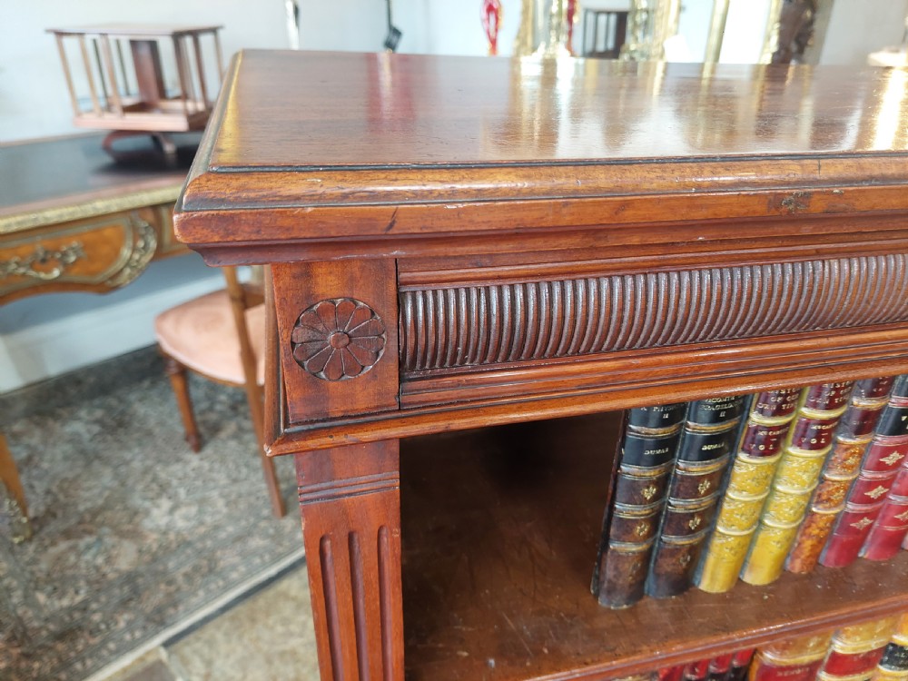 A late 19th-century mahogany dwarf open bookcase with a reeded top frieze, fluted side pilasters, and three fixed shelves. View III