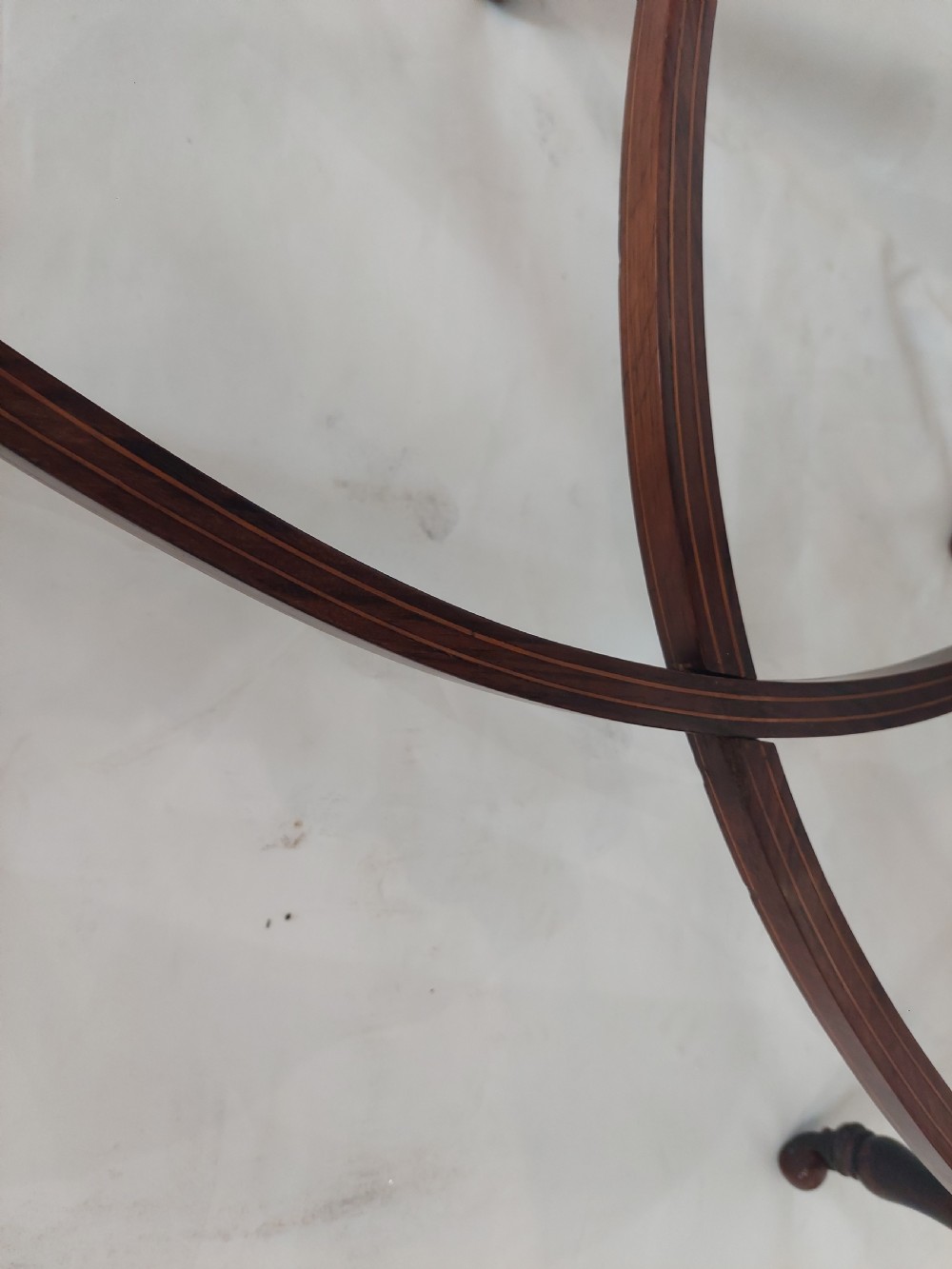 An Edwardian inlaid rosewood side table featuring a shaped top, fine line stringing, turned legs, and a curved X-form stretcher. View IV