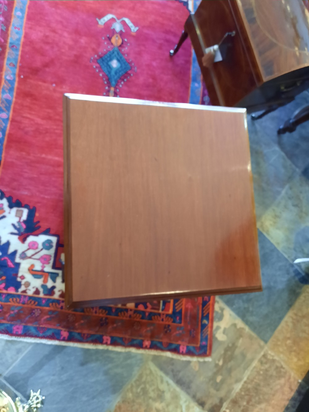 An Art Nouveau mahogany revolving bookcase featuring floral marquetry inlay on the side panel and two open tier shelves filled with leather-bound books. View IV
