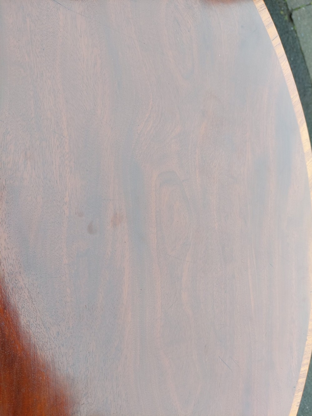 A George III mahogany demi-lune tea table featuring a fold-over top with crossbanded inlay and square tapered legs. View VI