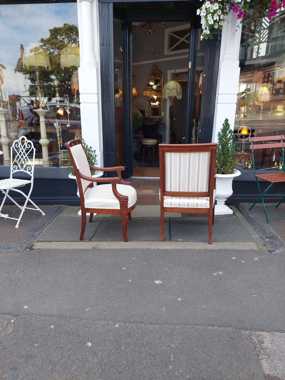 A pair of late 19th-century carved mahogany open armchairs upholstered in cream striped fabric with gimp braid trim. View VIII
