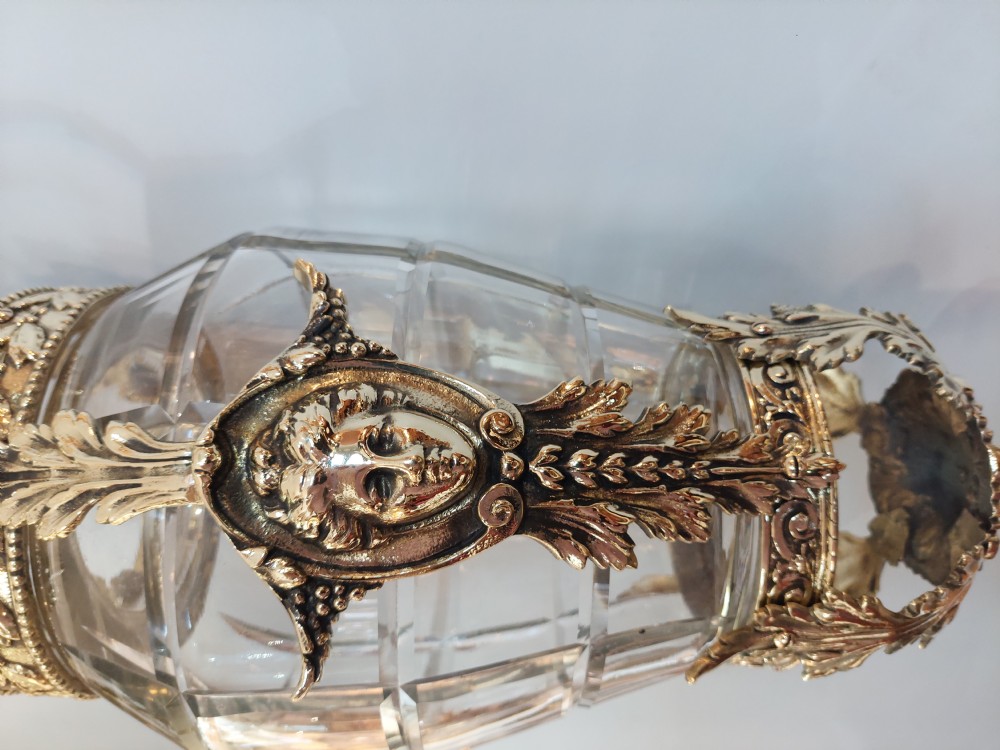 An early 20th-century brass hanging lantern featuring a cut glass shade, ornate leaf scrollwork framing, and a central suspension chain. View IX