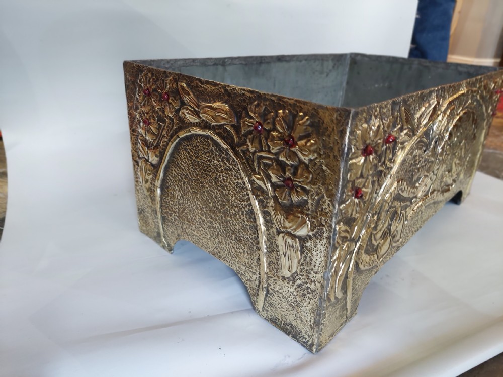 A rectangular brass trough planter featuring zinc lining and hand-chased relief work of a dragon among floral branches inset with red glass cabochons. View III