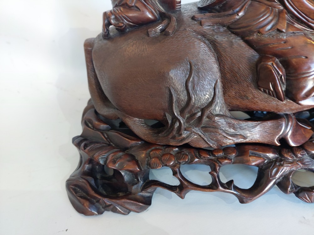 A 19th-century Chinese carved root wood sculpture depicting two boys riding a reclining water buffalo set upon a carved pierced base. View IV