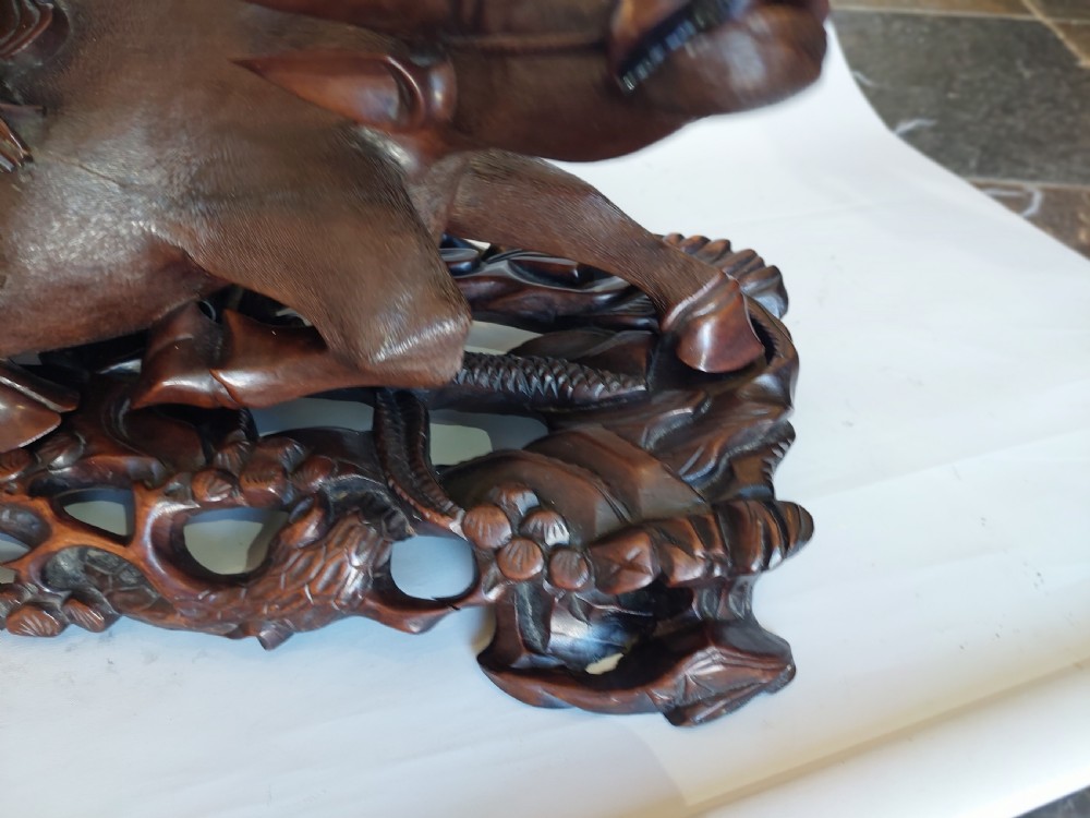 A 19th-century Chinese carved root wood sculpture depicting two boys riding a reclining water buffalo set upon a carved pierced base. View VI