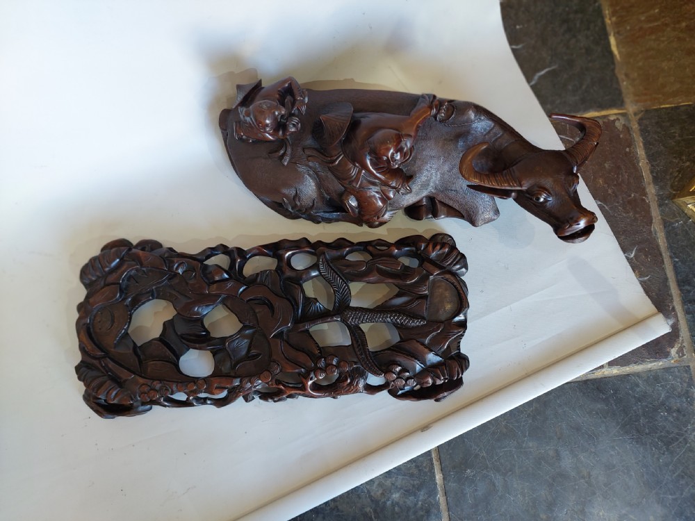 A 19th-century Chinese carved root wood sculpture depicting two boys riding a reclining water buffalo set upon a carved pierced base. View VIII