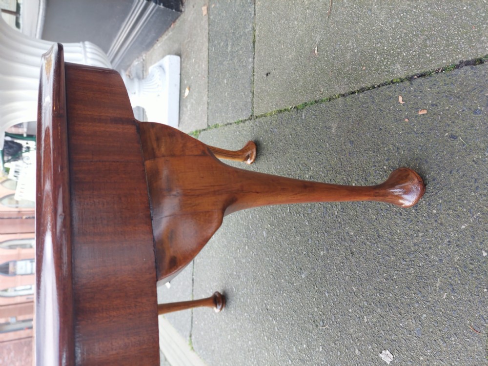 A circular 1920s burr walnut coffee table featuring cabriole legs with pad feet and a figure-grained veneer top. View III
