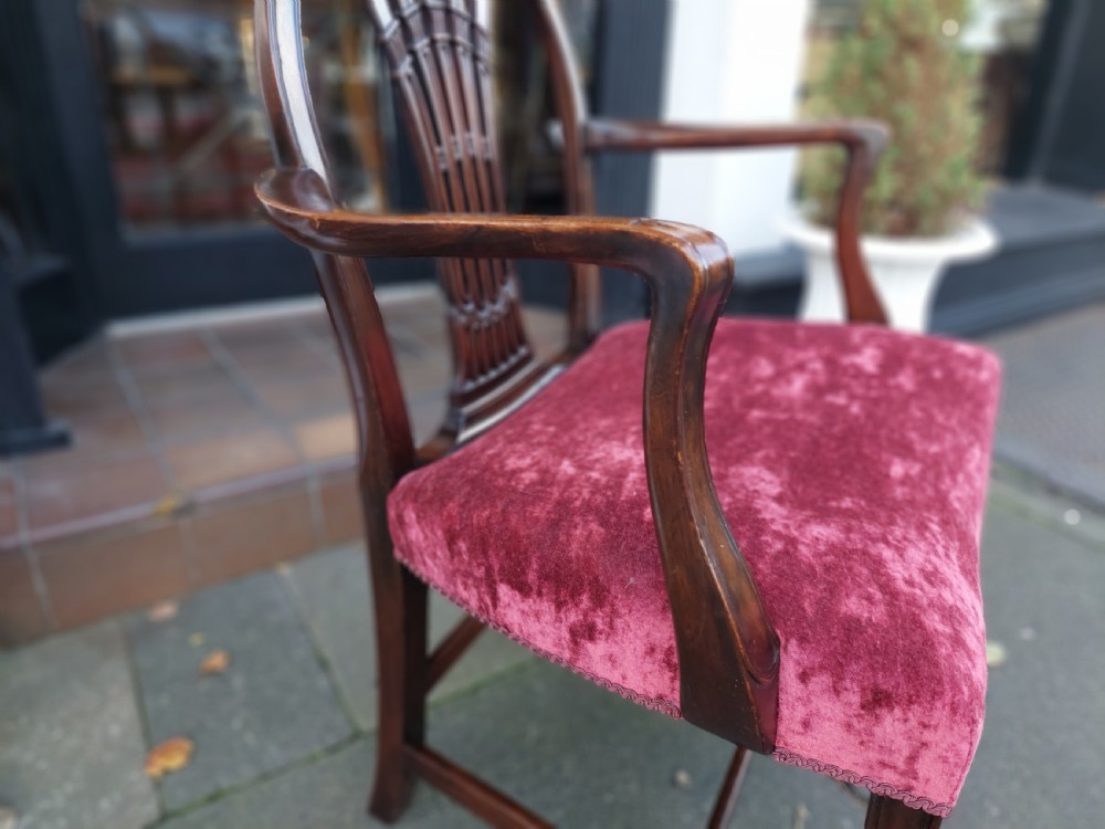 A late 19th-century Hepplewhite style mahogany armchair featuring a carved wheat sheaf oval backrest, curved arms, and a red velvet upholstered seat. View V