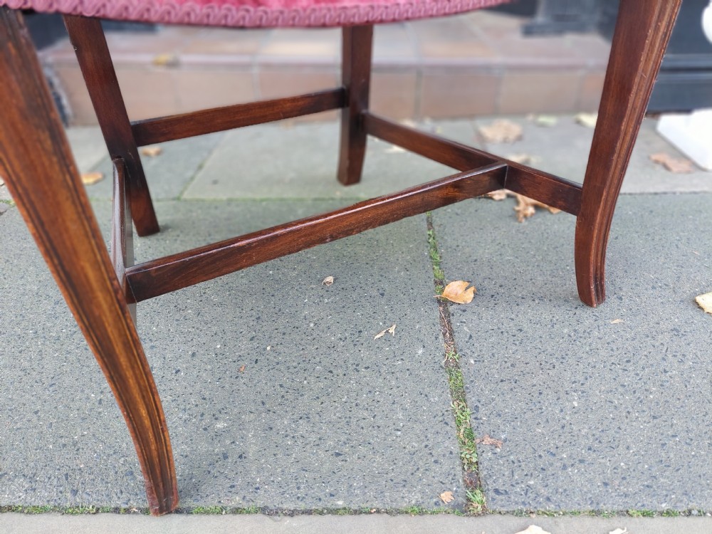 A late 19th-century Hepplewhite style mahogany armchair featuring a carved wheat sheaf oval backrest, curved arms, and a red velvet upholstered seat. View VII