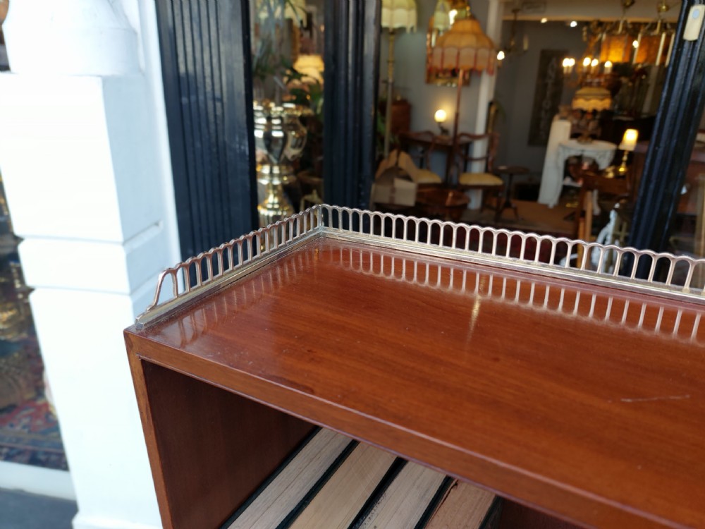 An Edwardian mahogany waterfall bookcase featuring two open graduated shelves above a two-door cabinet with oval satinwood marquetry inlay. View XII