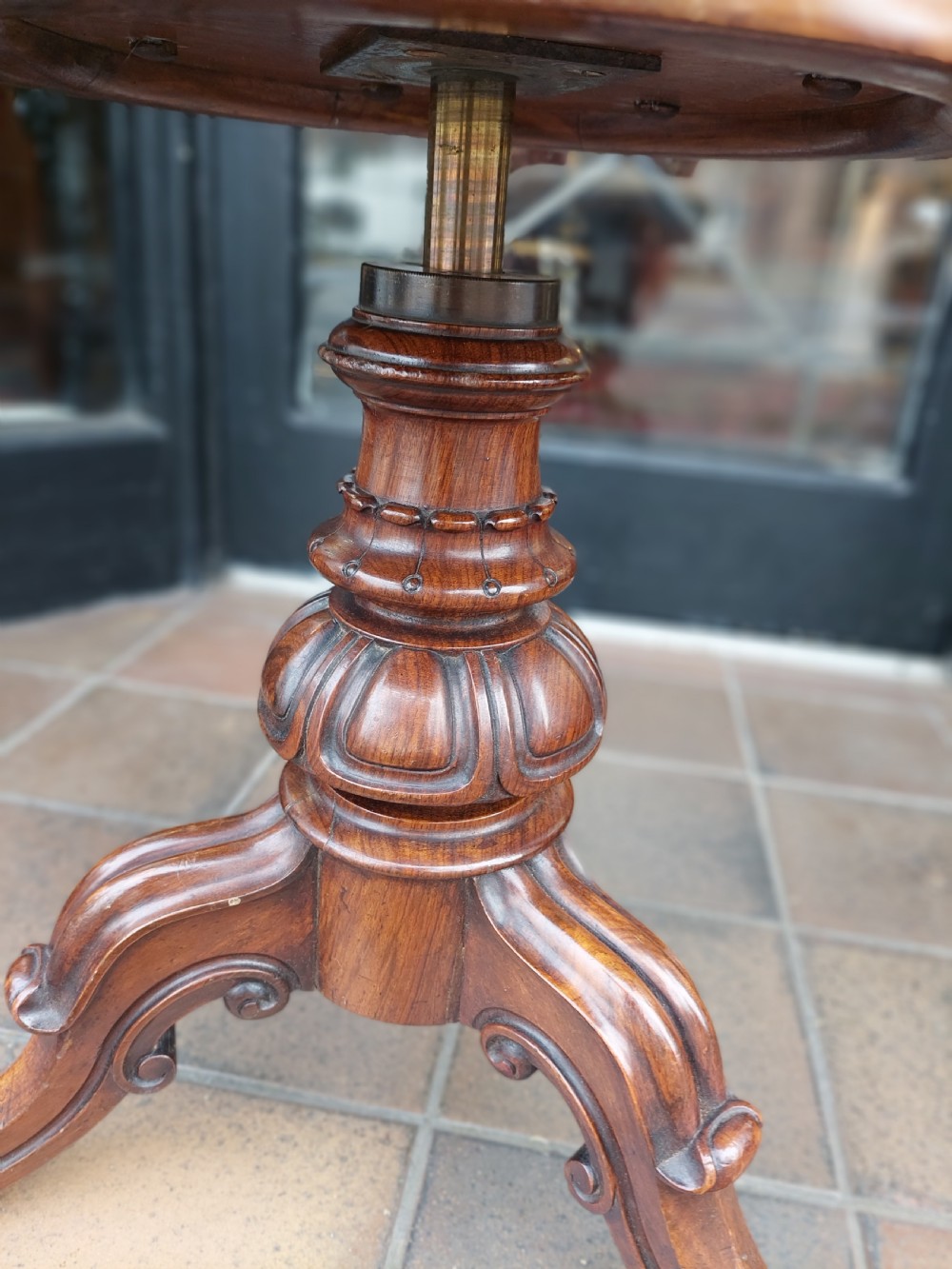 A Victorian dark walnut rise and fall piano stool with a circular cream upholstered seat and three carved cabriole legs with scroll feet. View III