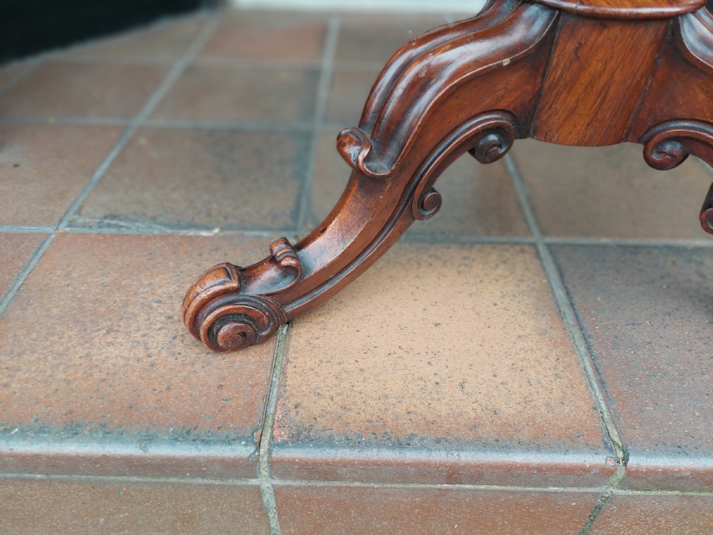 A Victorian dark walnut rise and fall piano stool with a circular cream upholstered seat and three carved cabriole legs with scroll feet. View VII