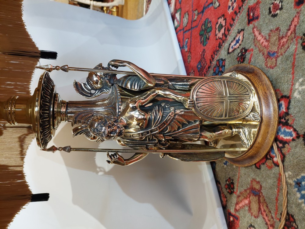 A late nineteenth-century brass table lamp featuring a sculptural base with classical soldier figures and a patterned hexagonal shade with long fringe. View III